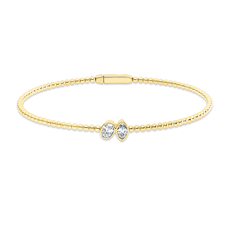 Armreif 18 kt GG, 1 Oval 0,22 ct, TW-si, 1 Nav. 0,17 ct, TW-si
