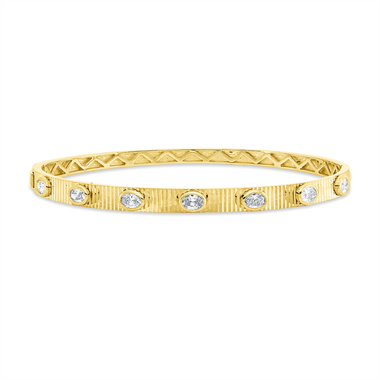 Armreif 18 kt GG, 7 Oval 0,73 ct, TW-si